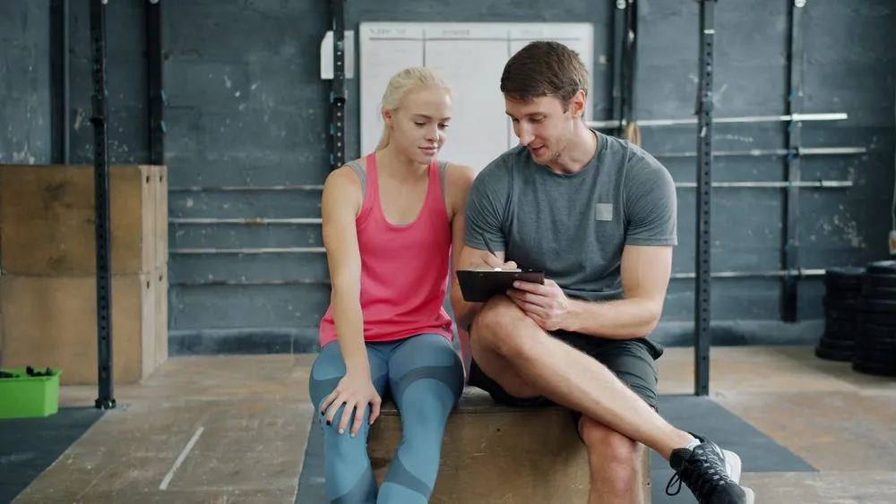 A coach discussing a training plan with a client